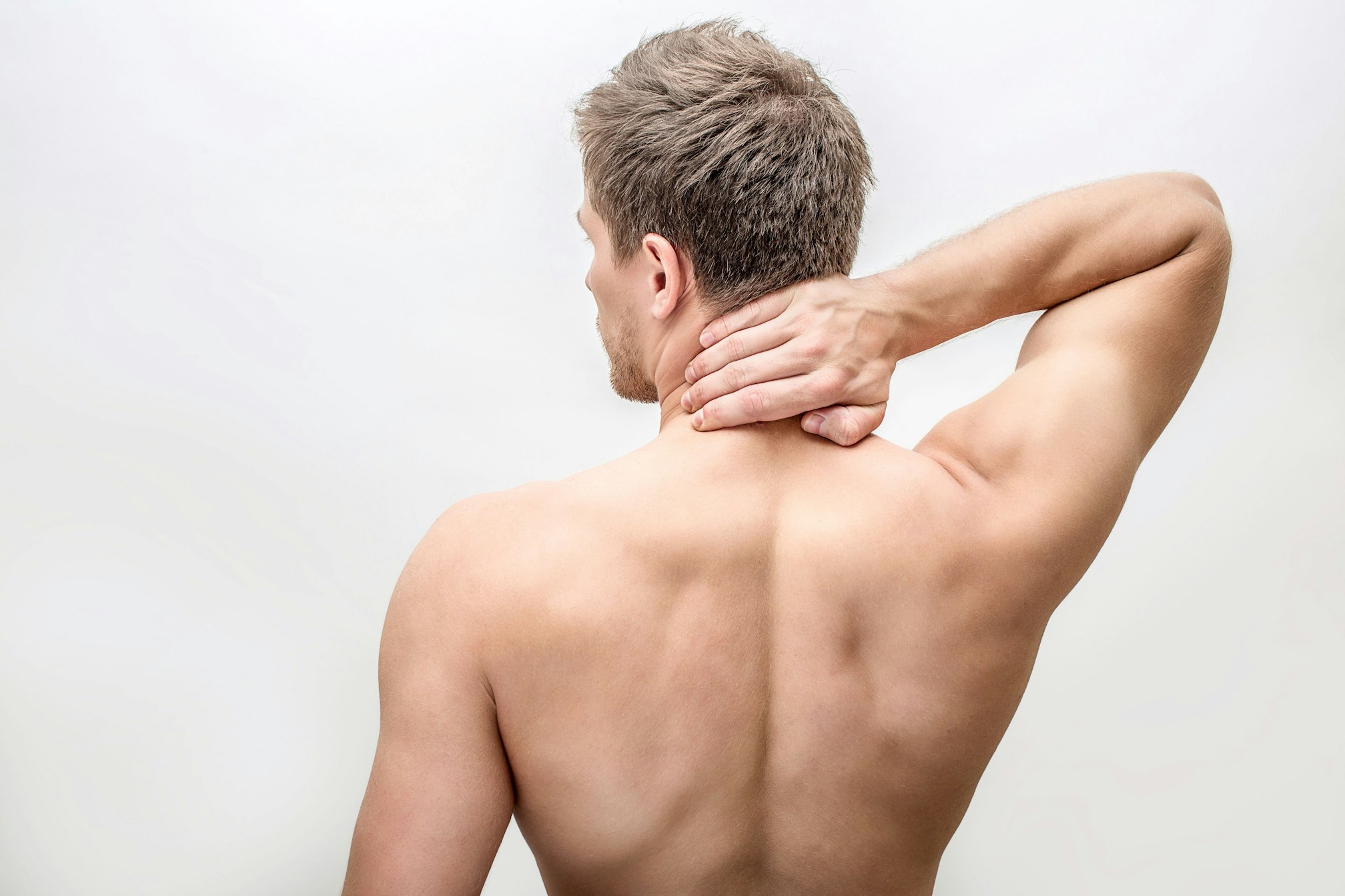 man grabbing back of neck