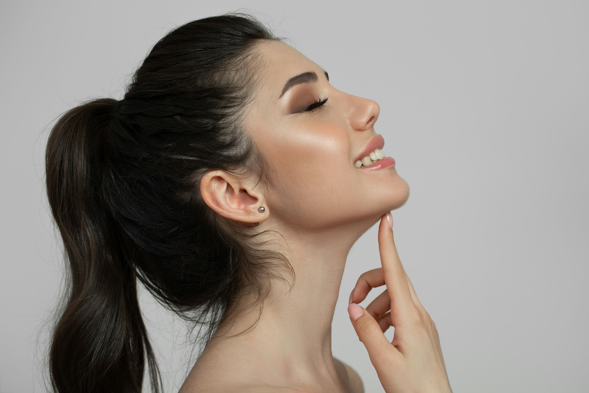 woman pointing at her jaw