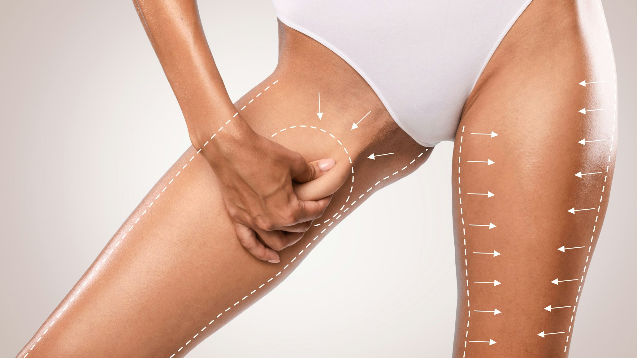 woman pinching inner thighs with arrows
