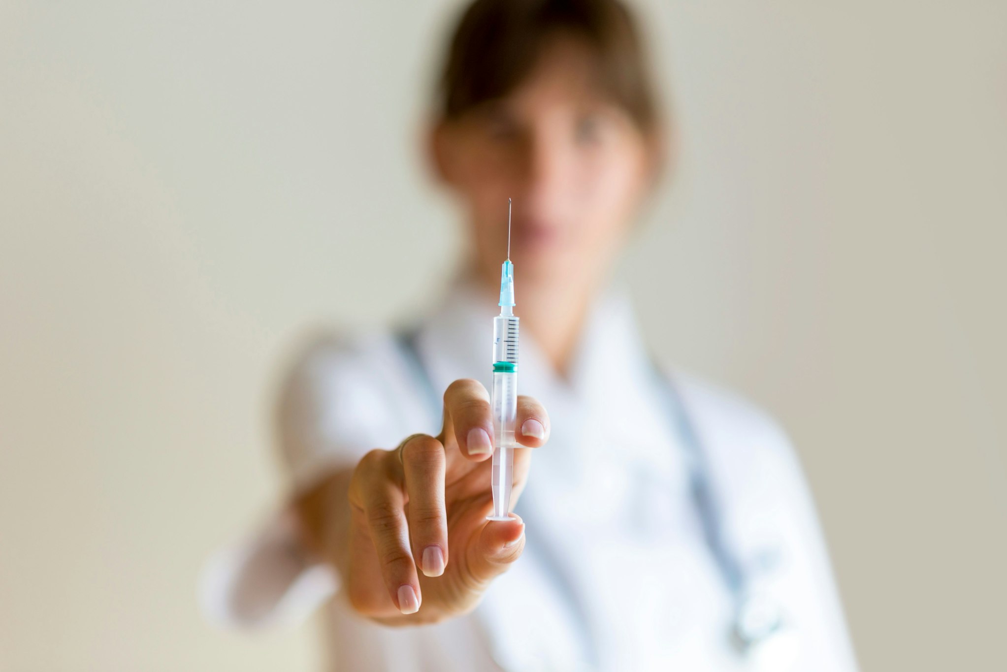 Doctor holding up needle