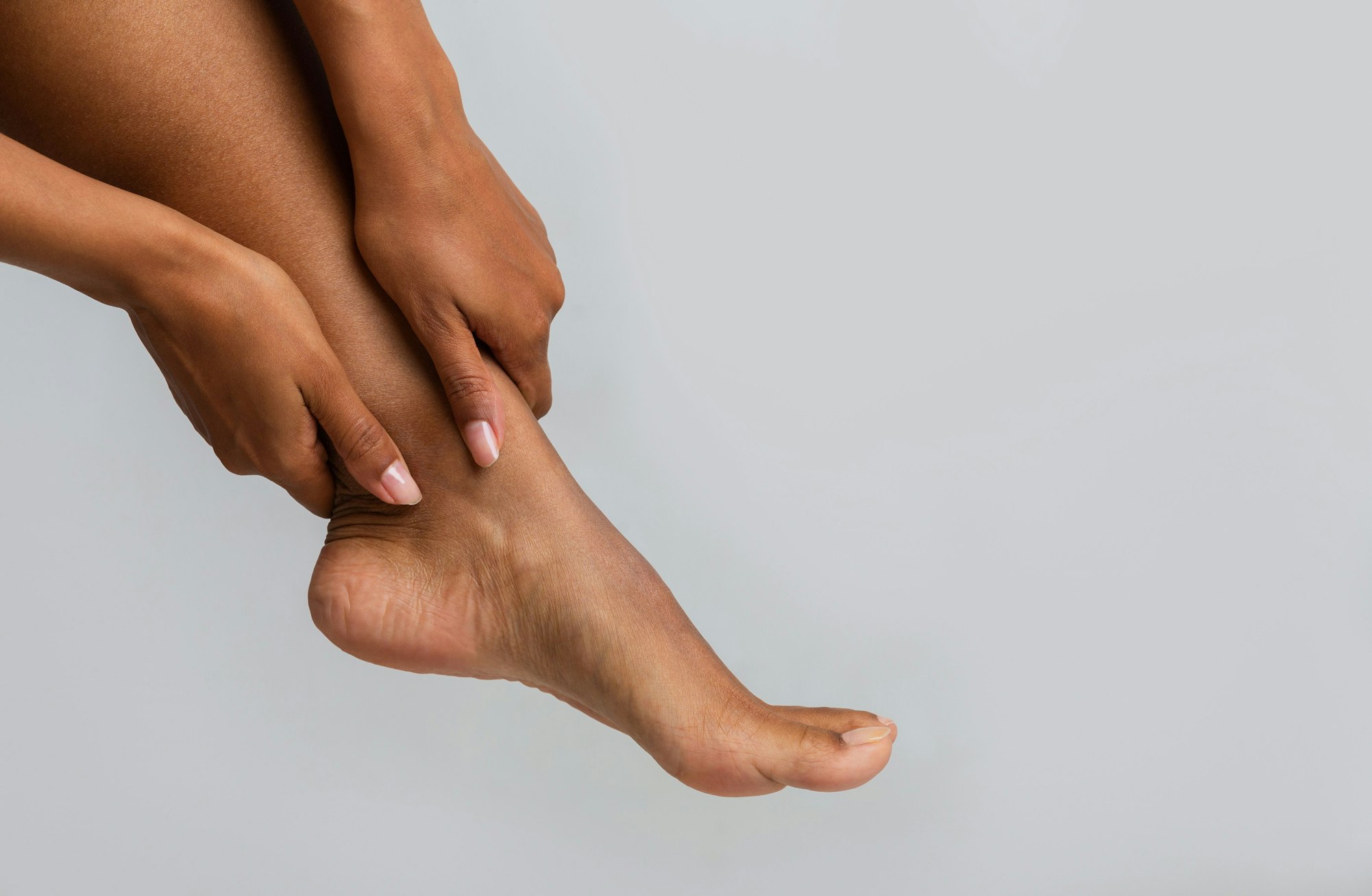 hands grabbing ankle