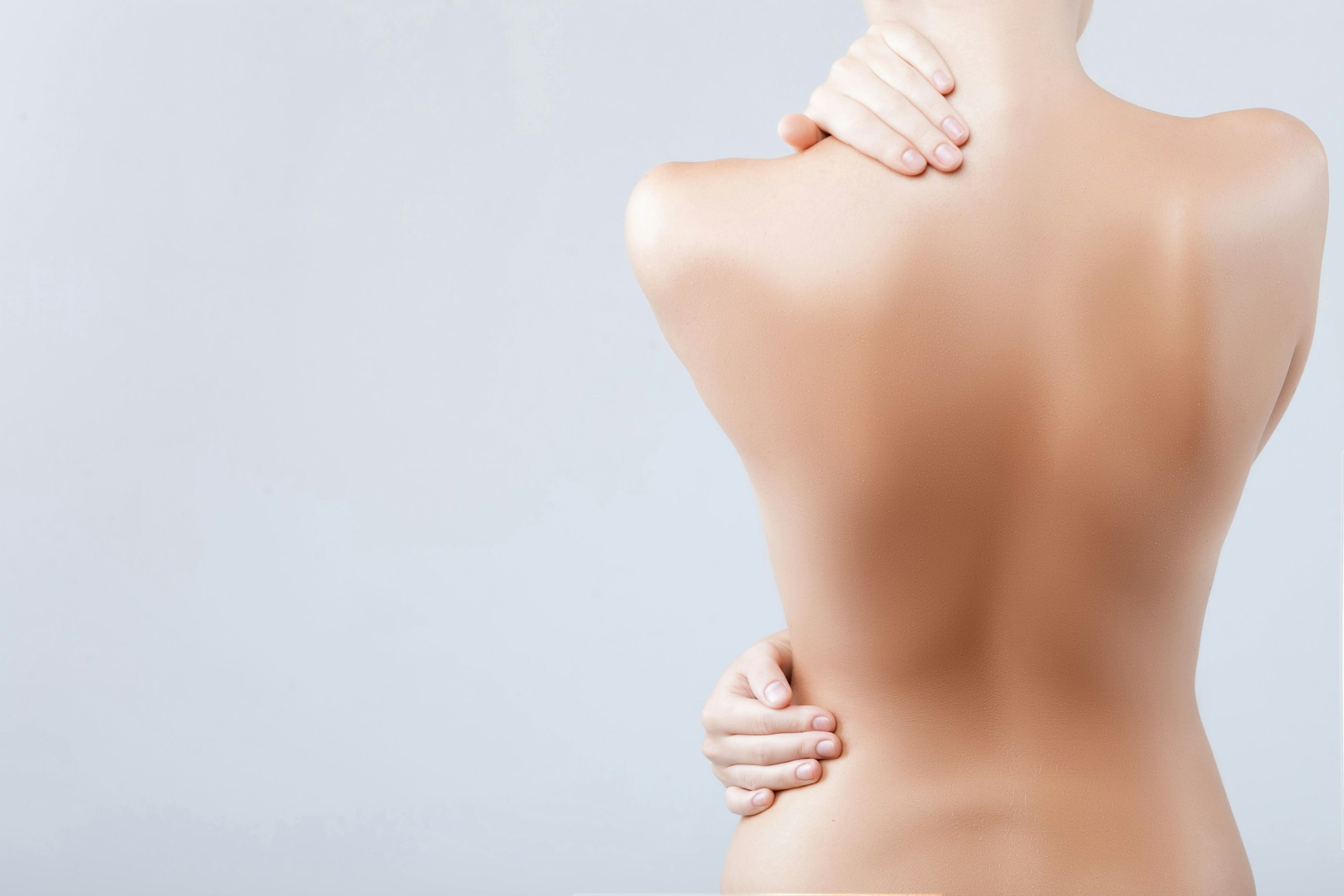 woman grabbing neck and back shirtless