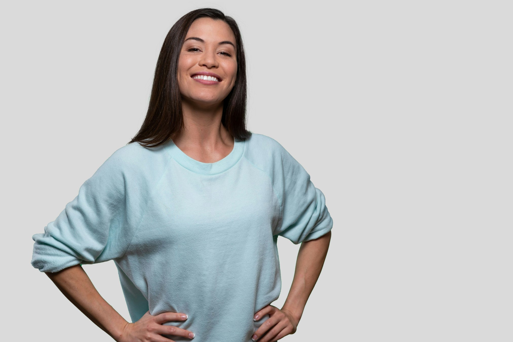 woman in blue shirt with hands on her hips