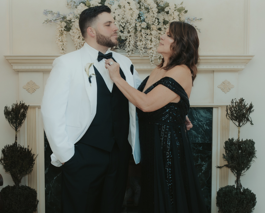 Woman helping her son, the groom, with his bow tie