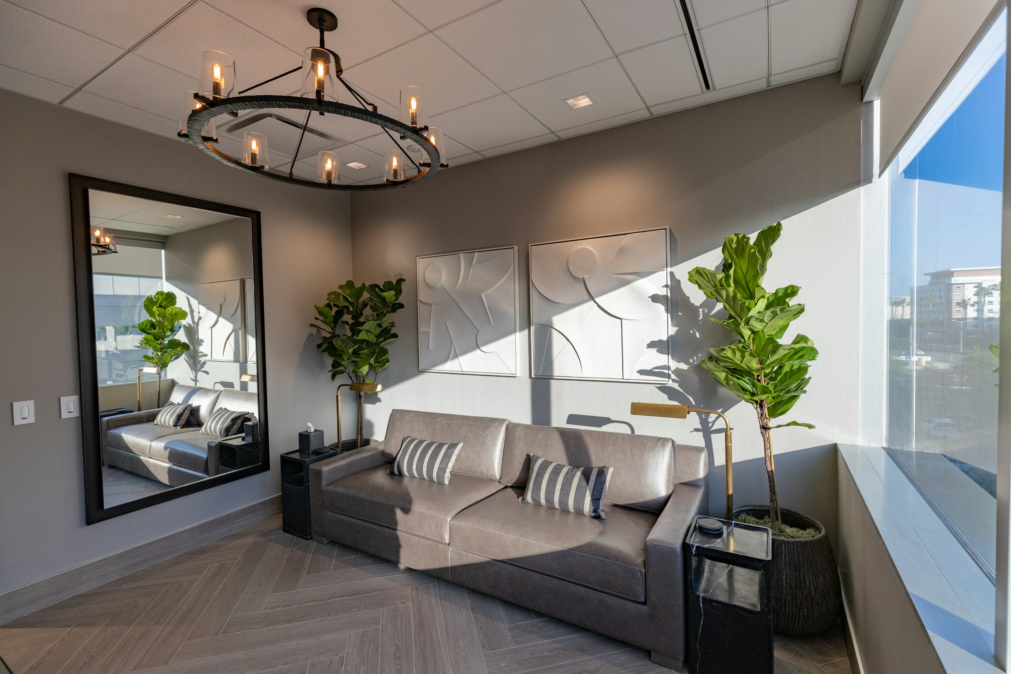 Couch and potted plant in AirSculpt Body Contouring Orange County clinic waiting area