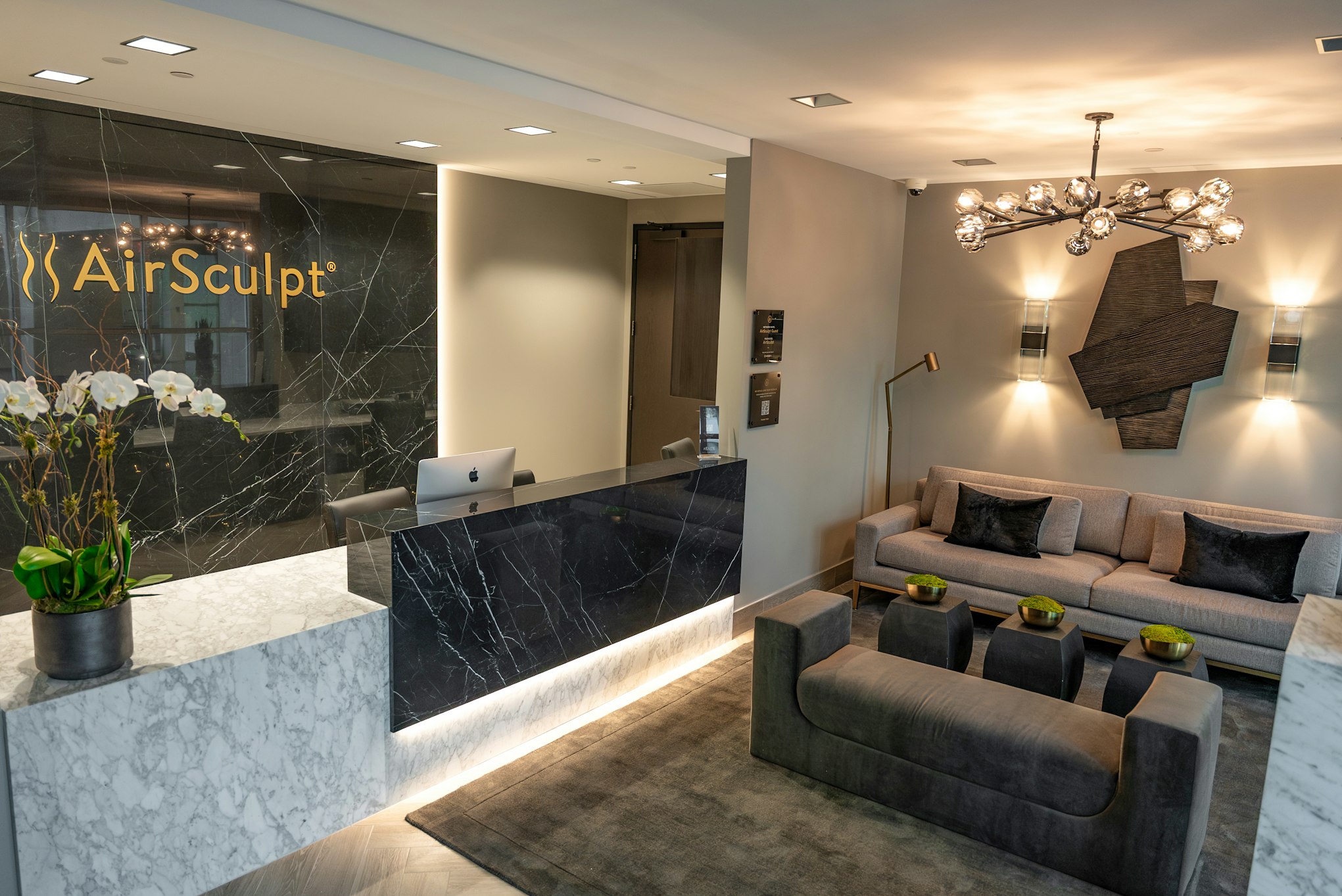 Front desk and couch in AirSculpt Body Contouring Atlanta clinic lobby