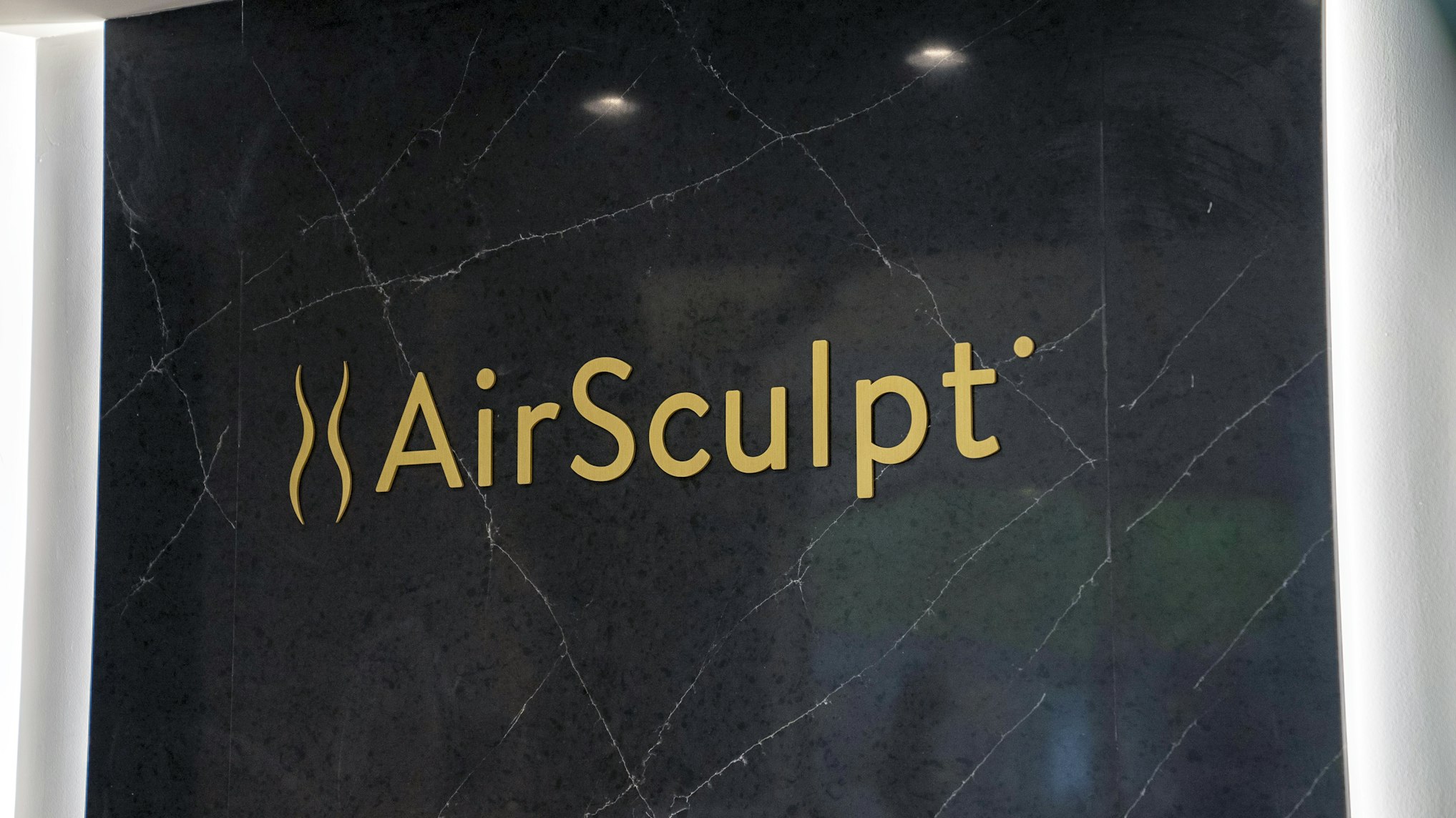 Backdrop featuring AirSculpt logo in AirSculpt Body Contouring Dallas clinic lobby