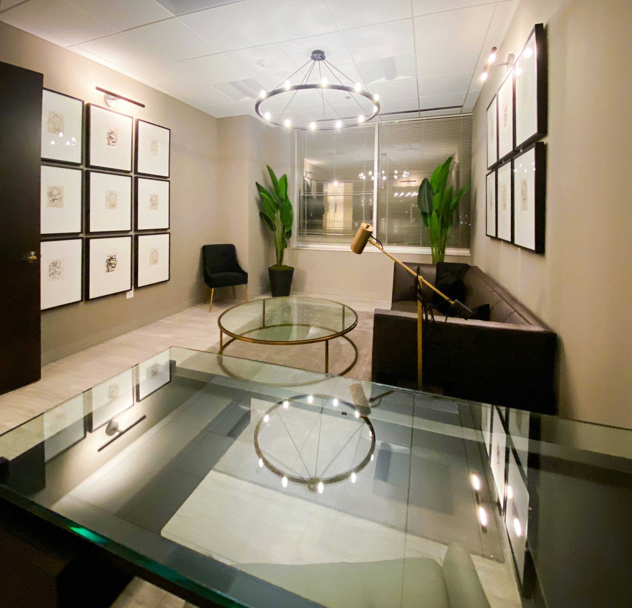 Glass‑topped coffee tables and chairs in AirSculpt Body Contouring Washington, D.C. clinic waiting area