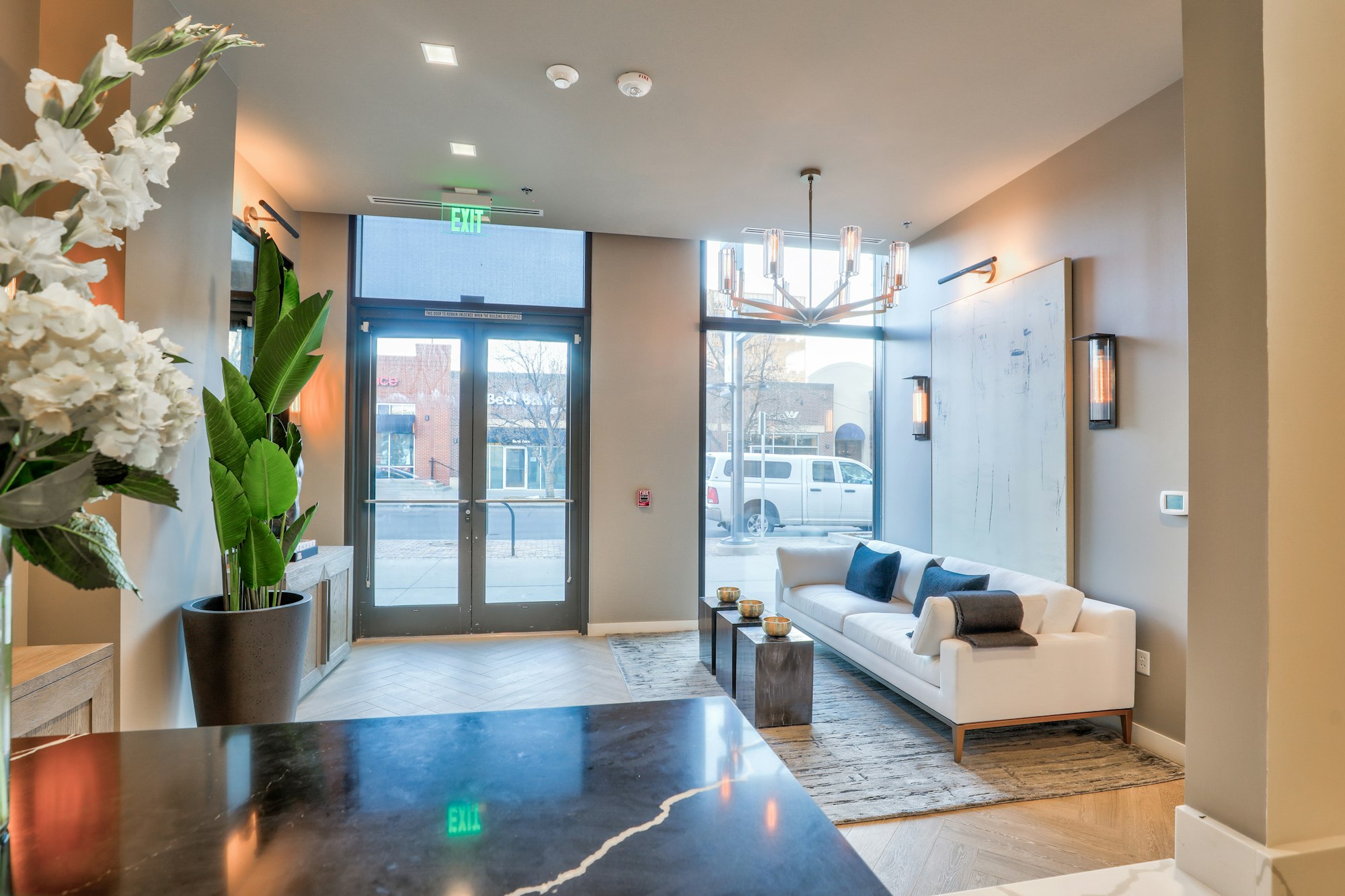 Couch and entrance doors in AirSculpt Body Contouring Denver clinic lobby