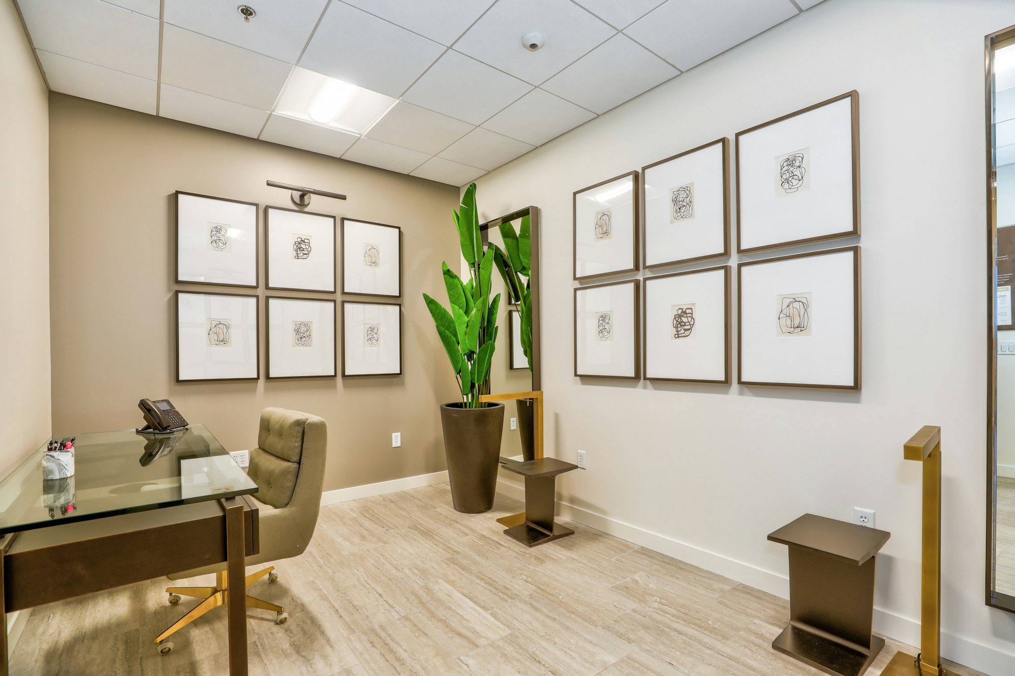 Chairs, desk and framed artwork in AirSculpt Body Contouring Denver clinic consultation room