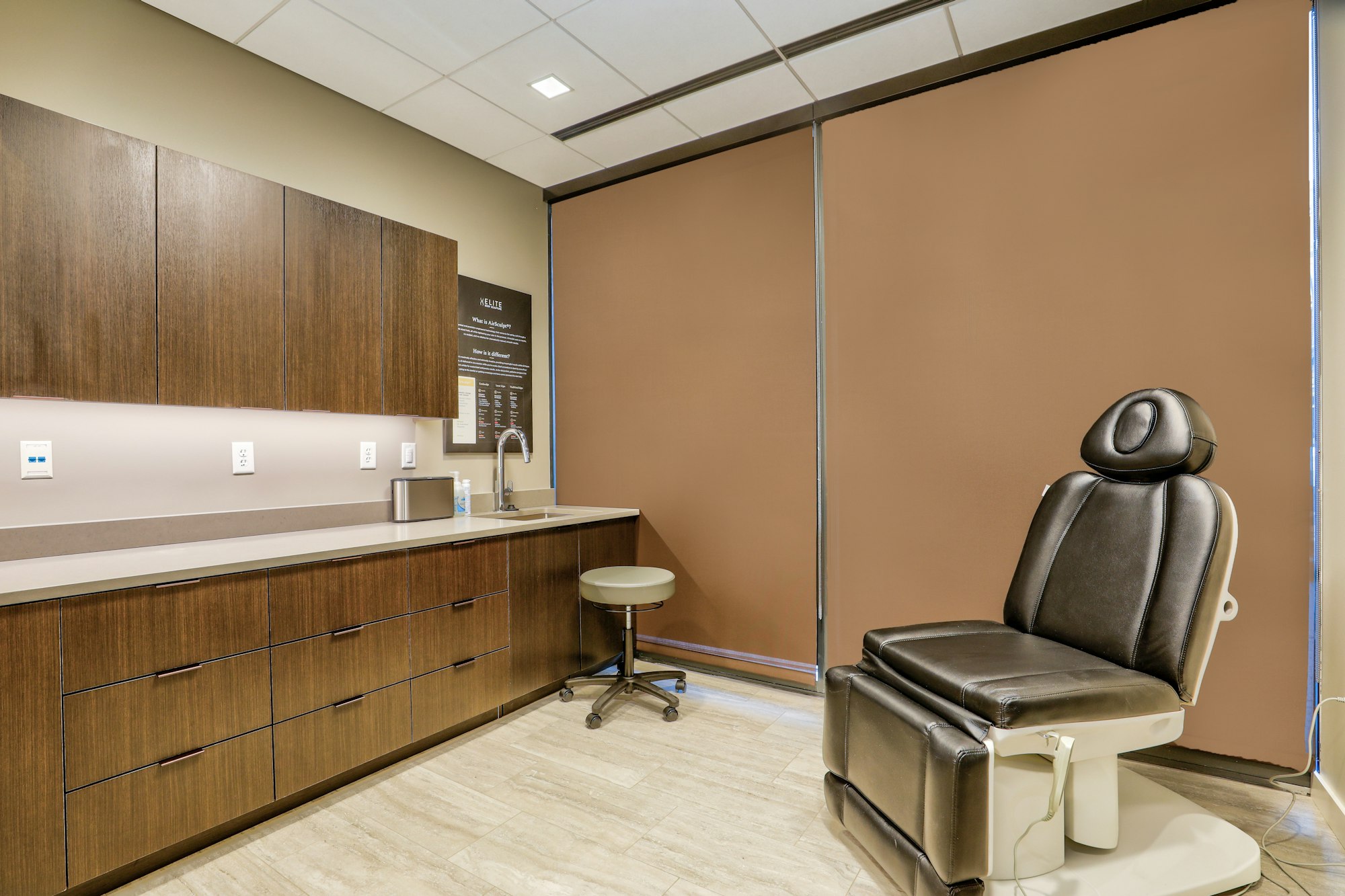 Recovery room with chair and cabinetry in AirSculpt Body Contouring Denver clinic