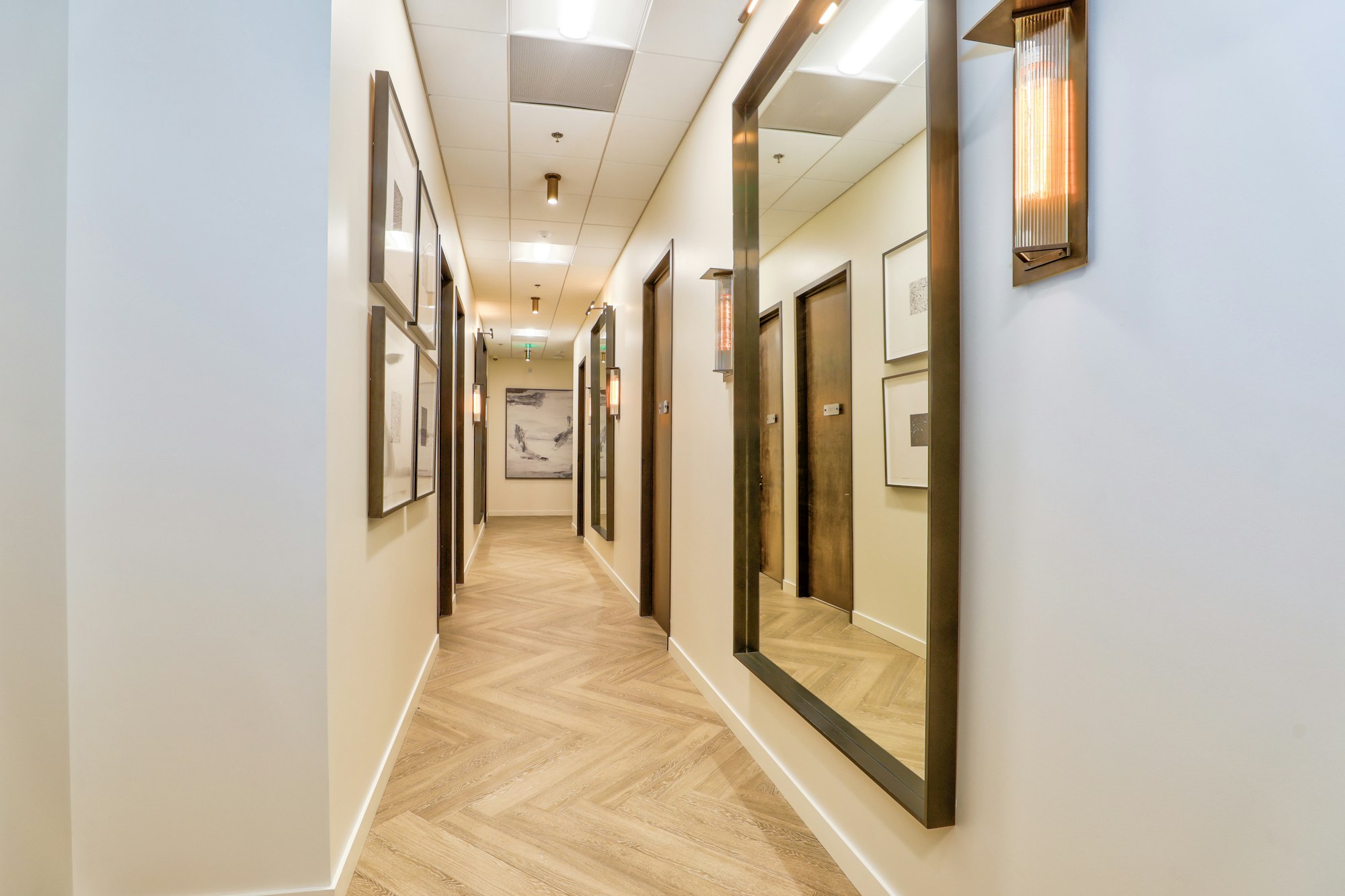 Hallway with herringbone wood floor in AirSculpt Body Contouring Denver clinic