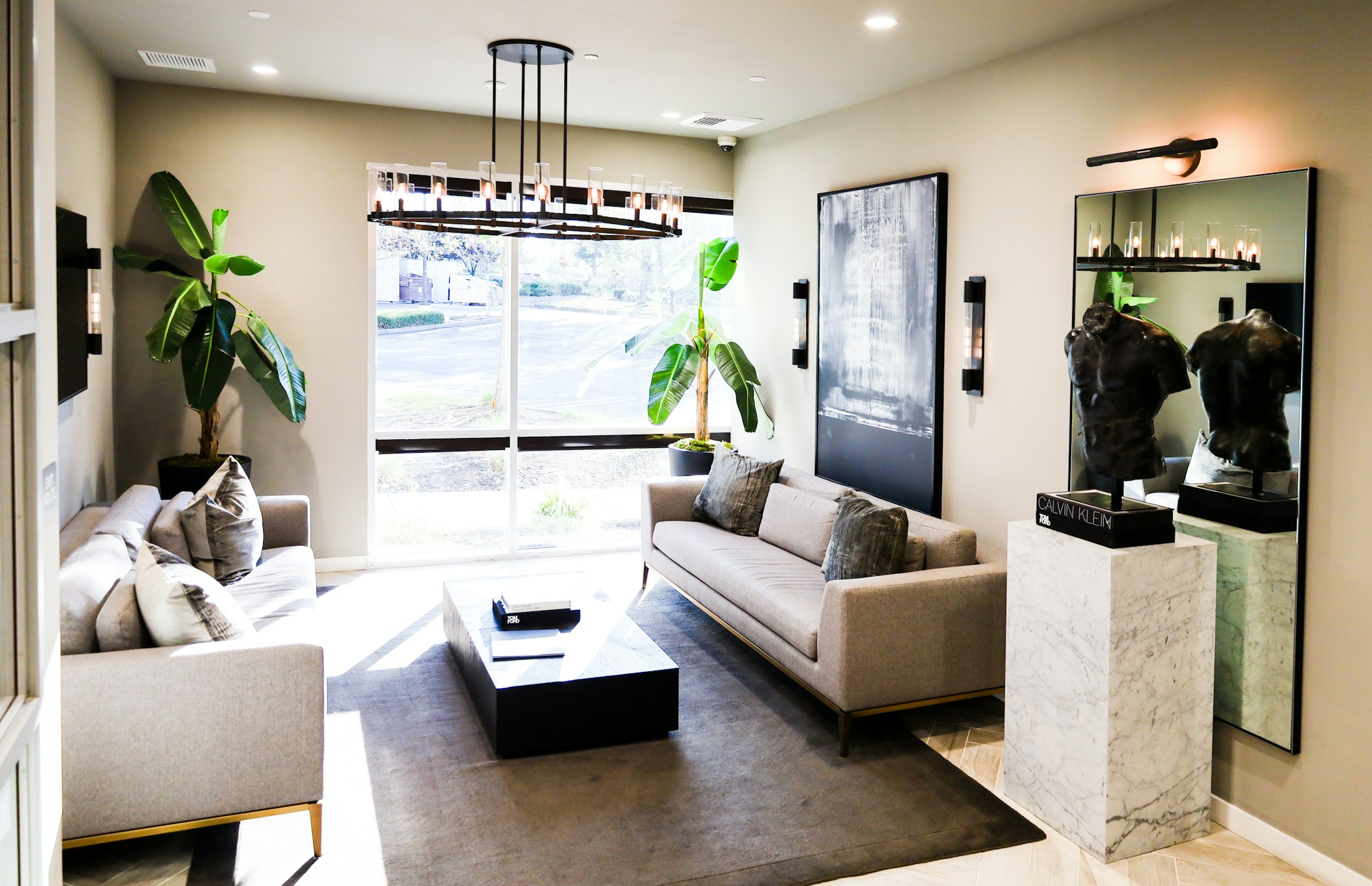 Couch and coffee table beneath chandelier in AirSculpt Body Contouring Sacramento clinic lobby