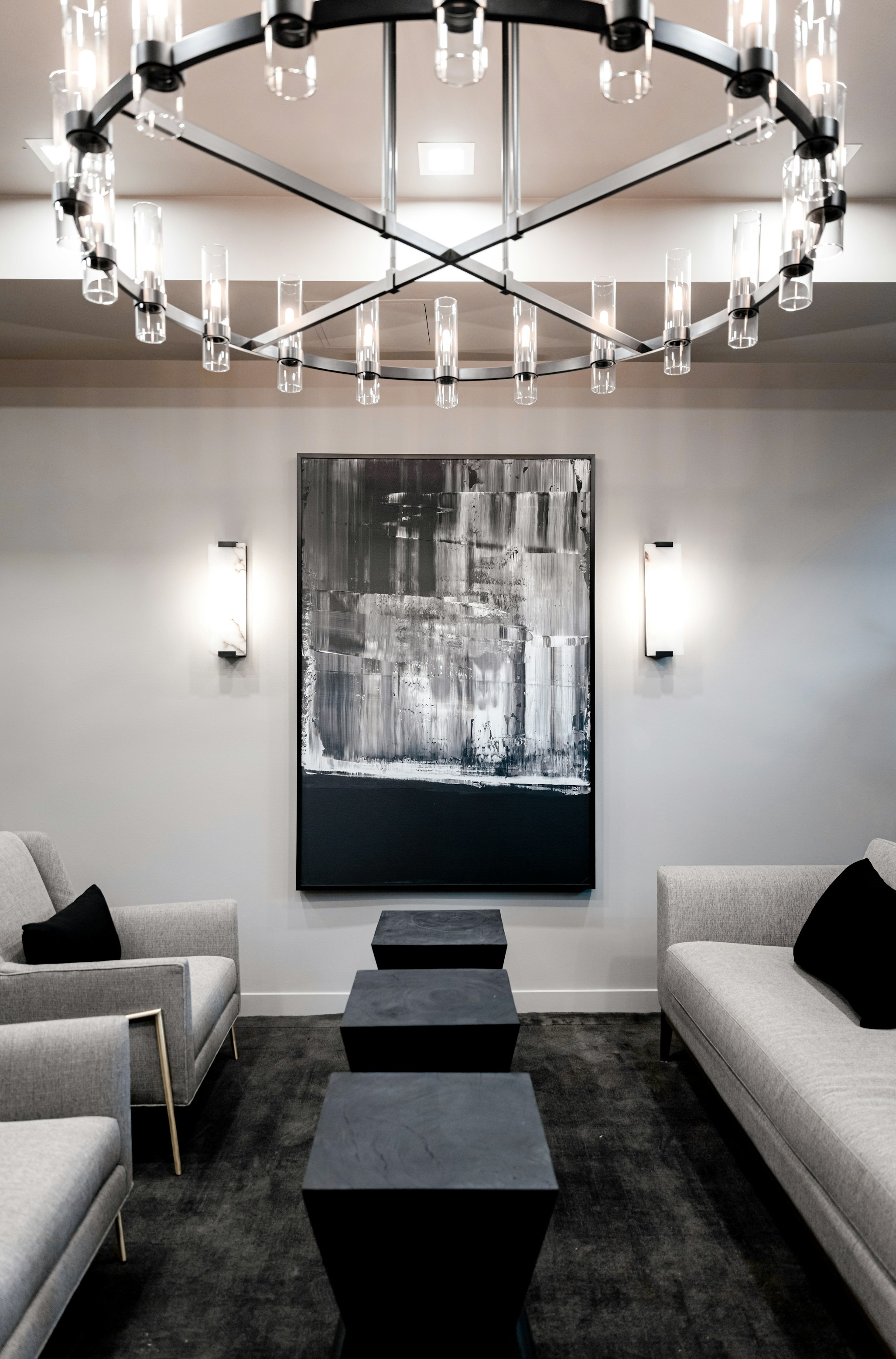Chandelier, chairs, couch, and abstract wall art in AirSculpt Body Contouring Salt Lake City clinic lobby