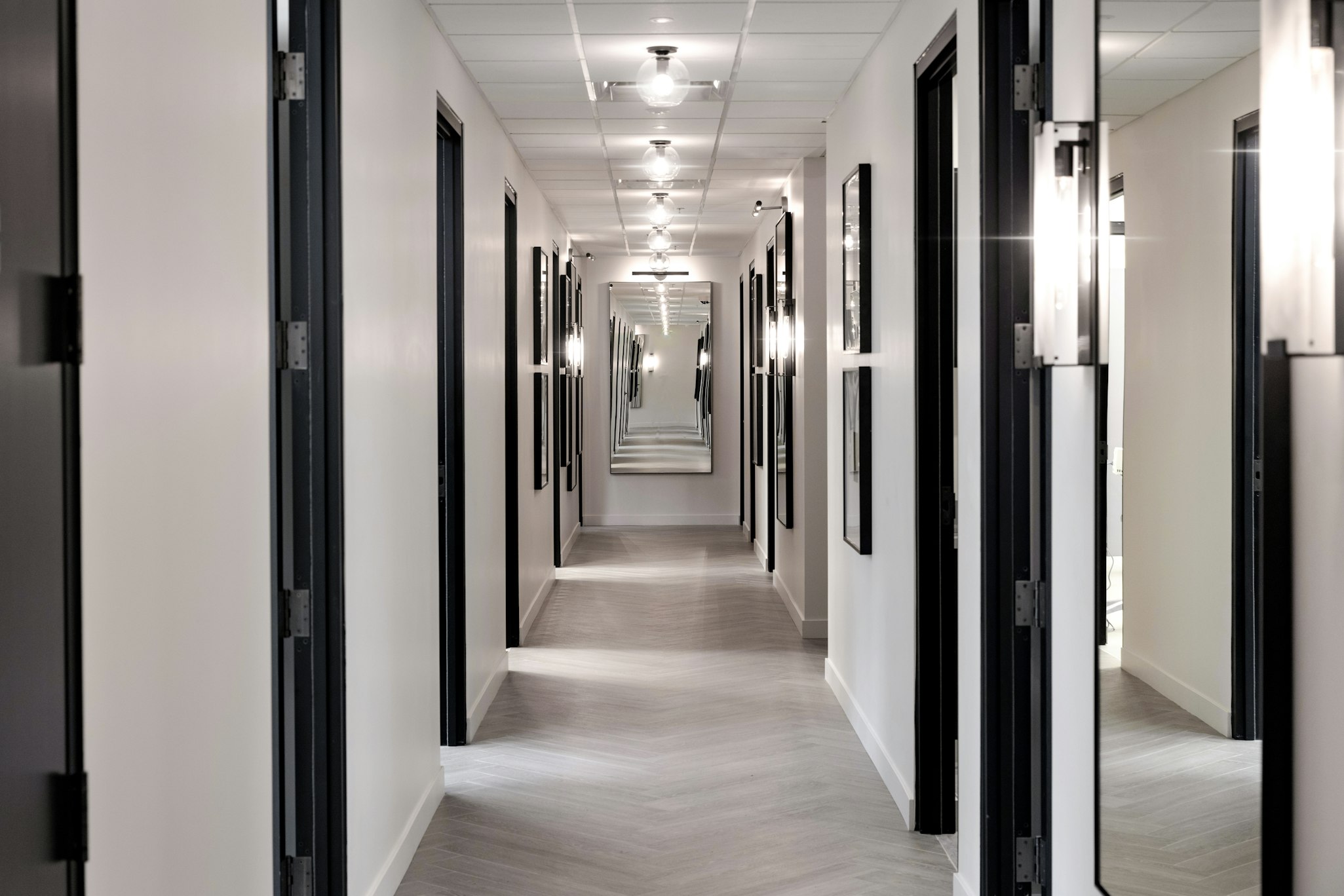 Hallway with recessed lighting and doorways in AirSculpt Body Contouring Salt Lake City clinic