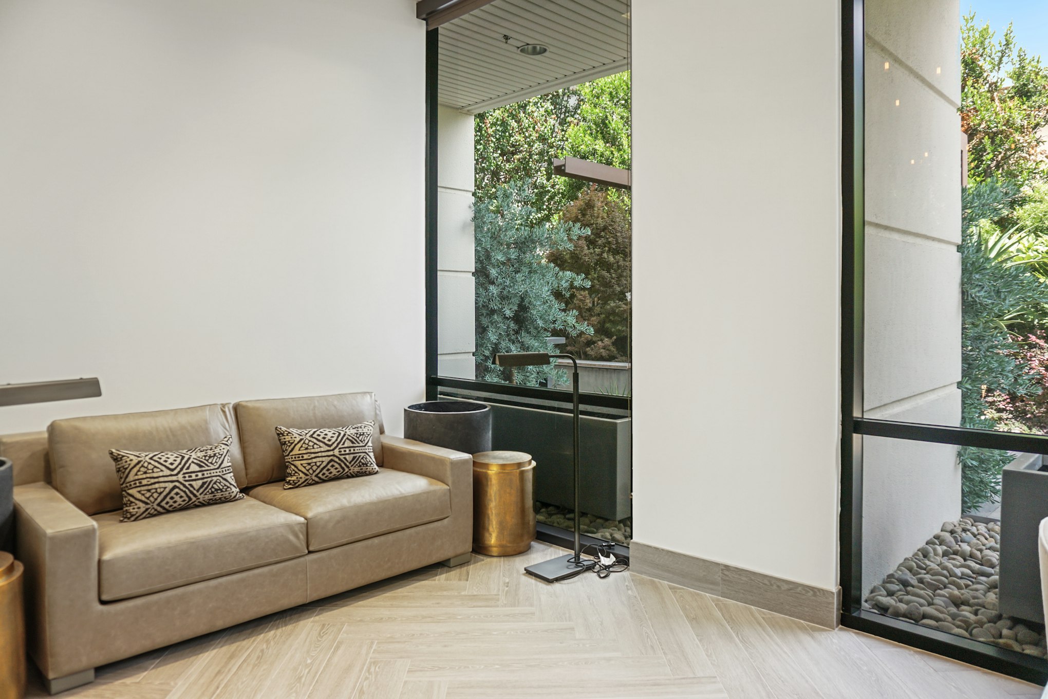 Couch and potted plant in AirSculpt Body Contouring San Jose clinic waiting area