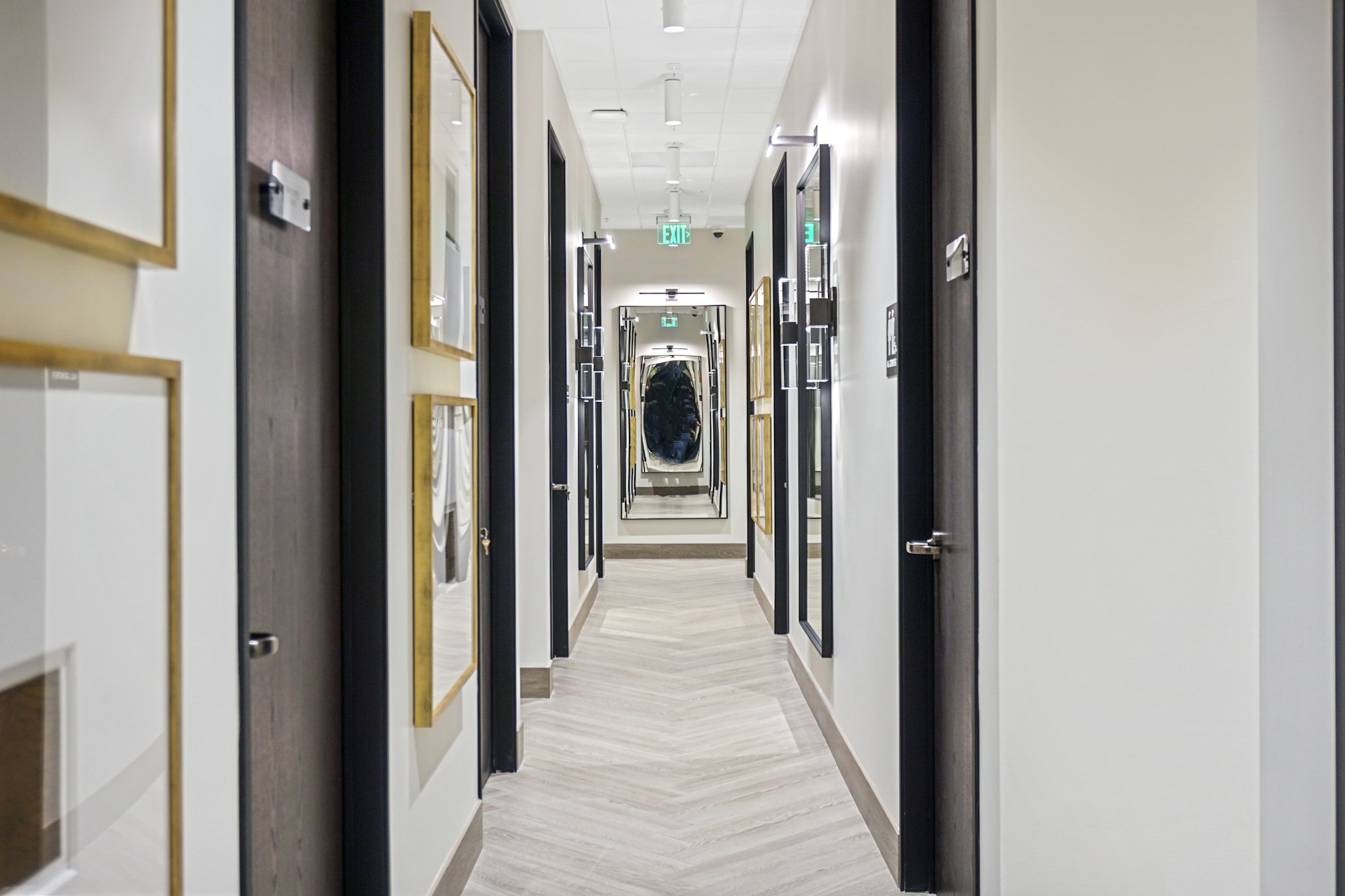 Hallway with framed artwork and doorways in AirSculpt Body Contouring San Jose clinic
