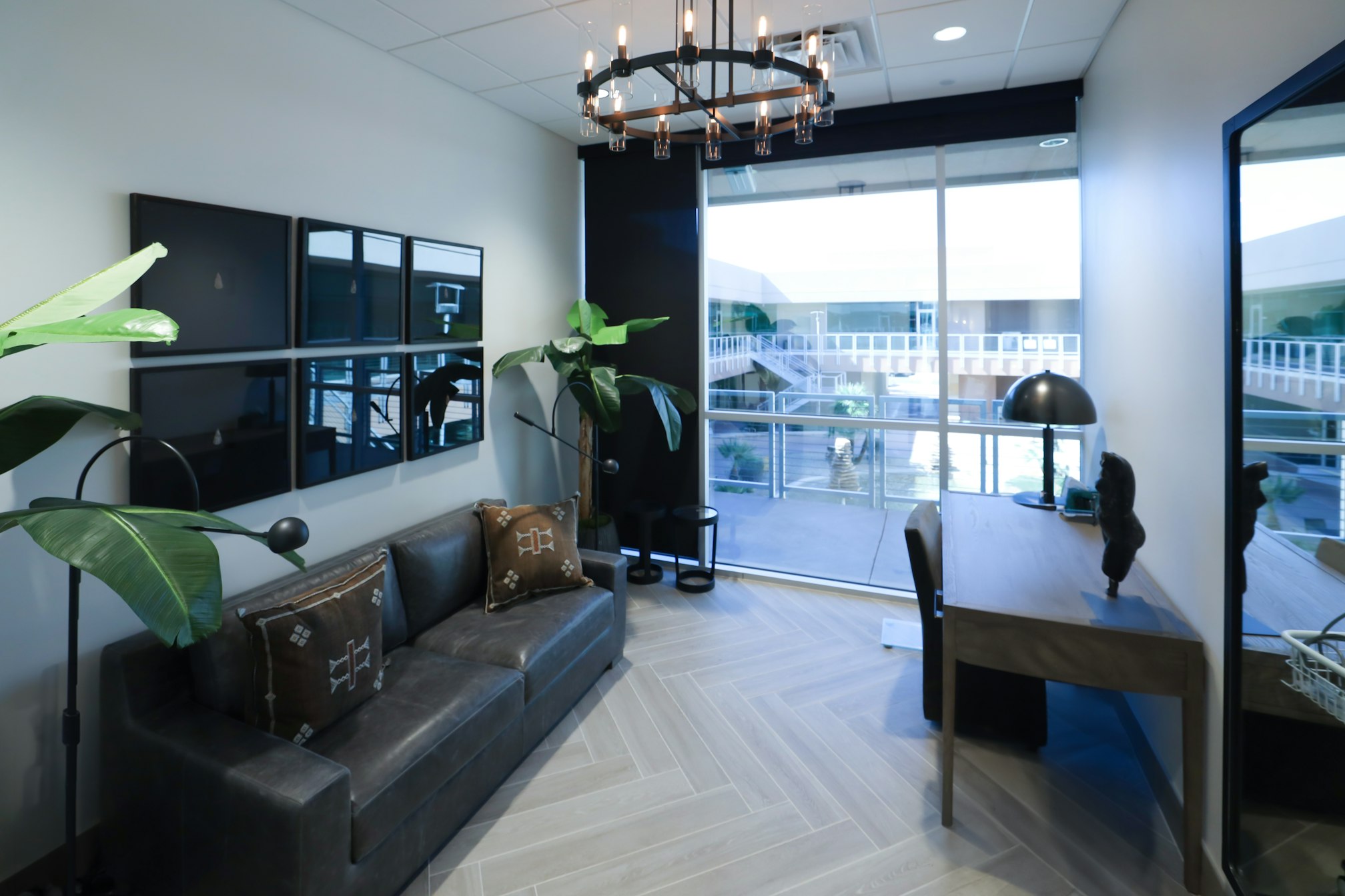 Consultation room with couch, desk, and wall‑mounted television in AirSculpt Body Contouring Scottsdale clinic