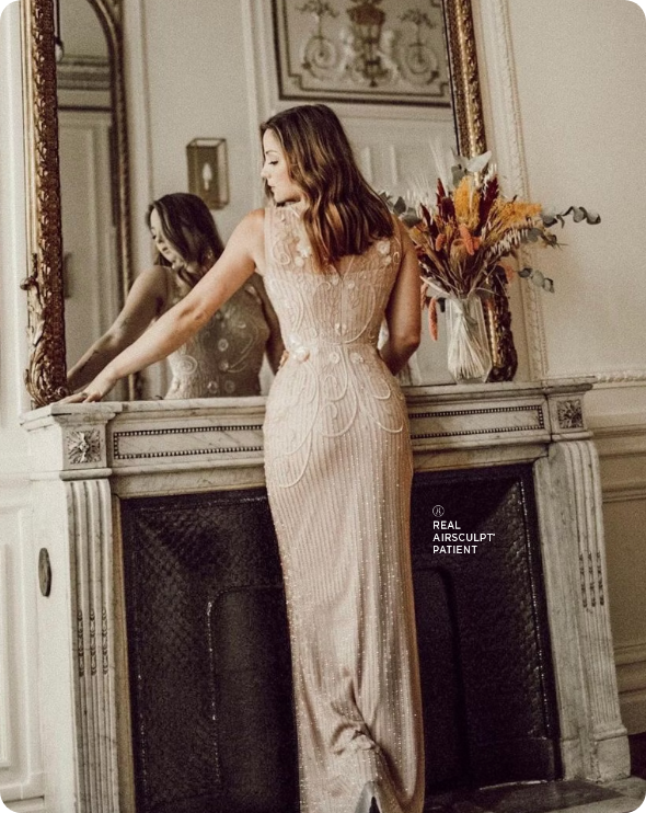 woman in gold dress in front of mirror
