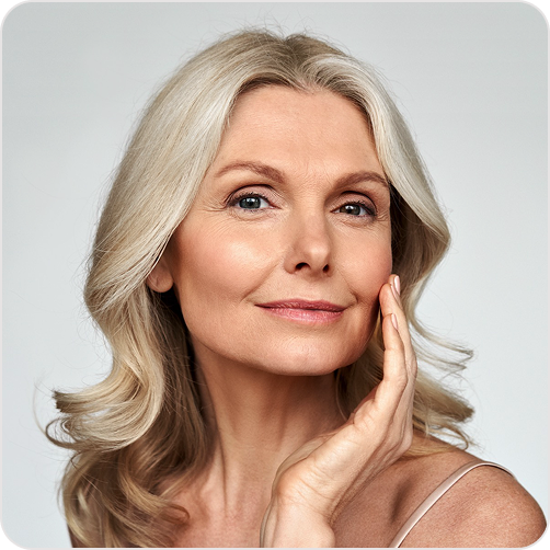 Older woman touching her face