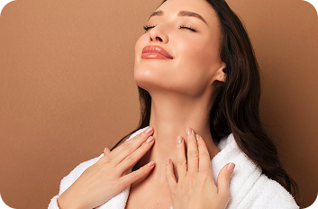Young woman touching her neck and smiling.