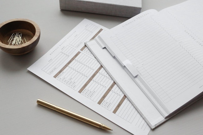 A budgeting worksheet sits atop a table