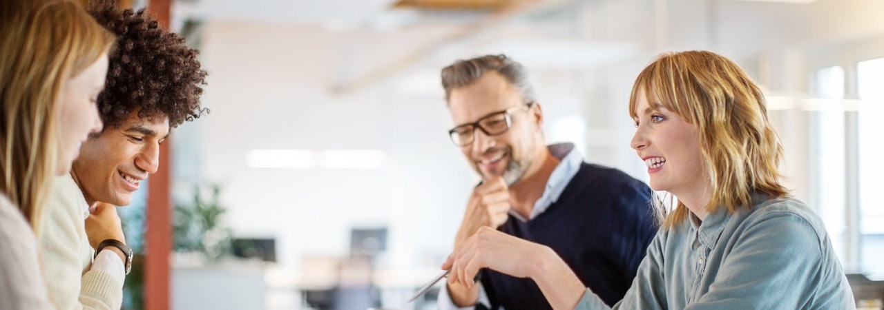A group of people discussing around a table