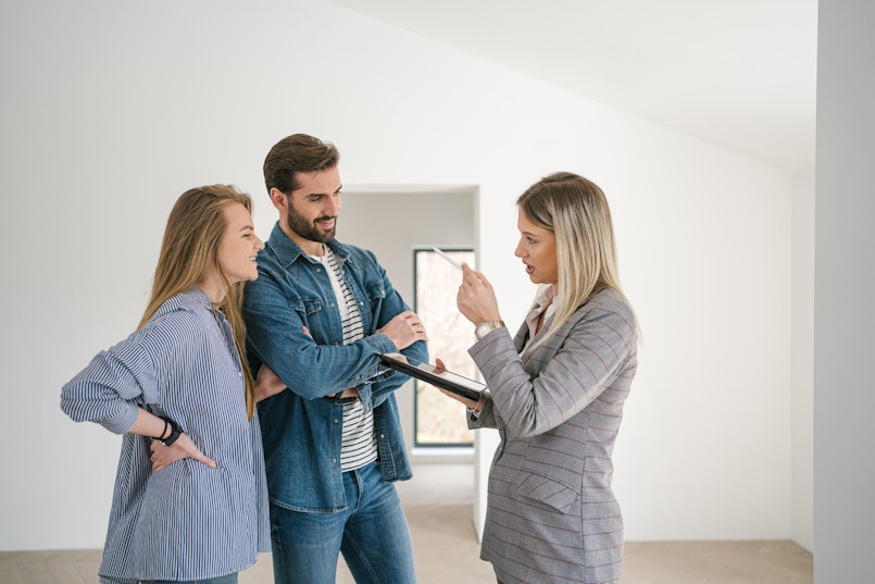 Young couple inspecting their condo with agent