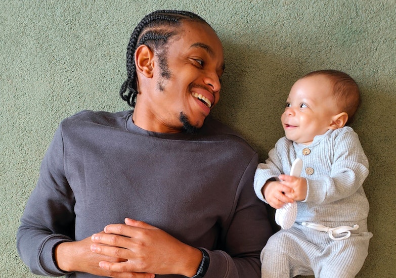 Father and Infant son laying on floor