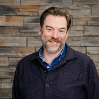 a headshot portrait of Geoffrey McGrath