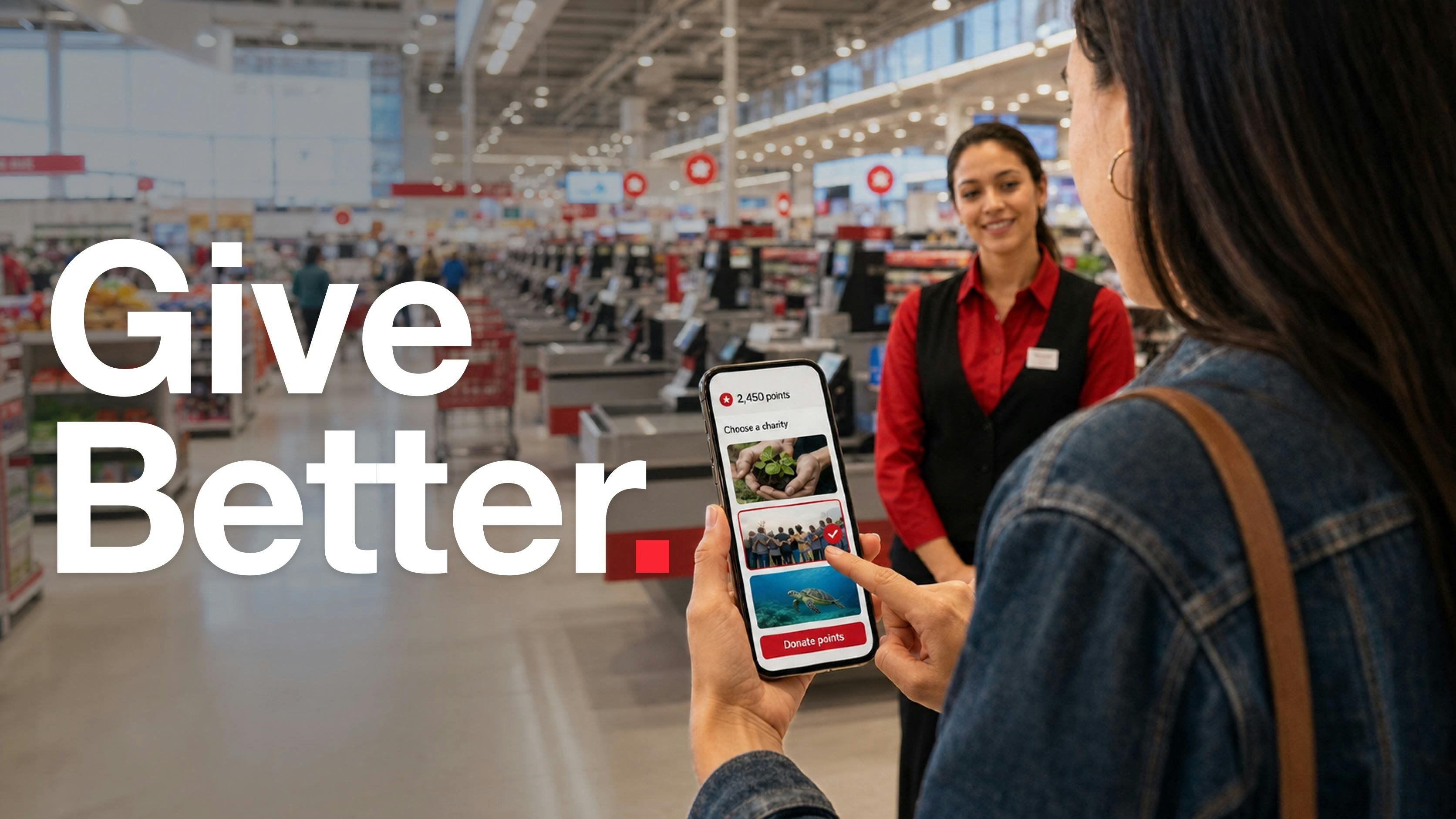 Choosing a cause with loyalty points at checkout A shopper in a large retail store holds a phone showing a rewards screen with a points balance, three cause options to choose from, and a button to donate points. A store employee stands nearby.