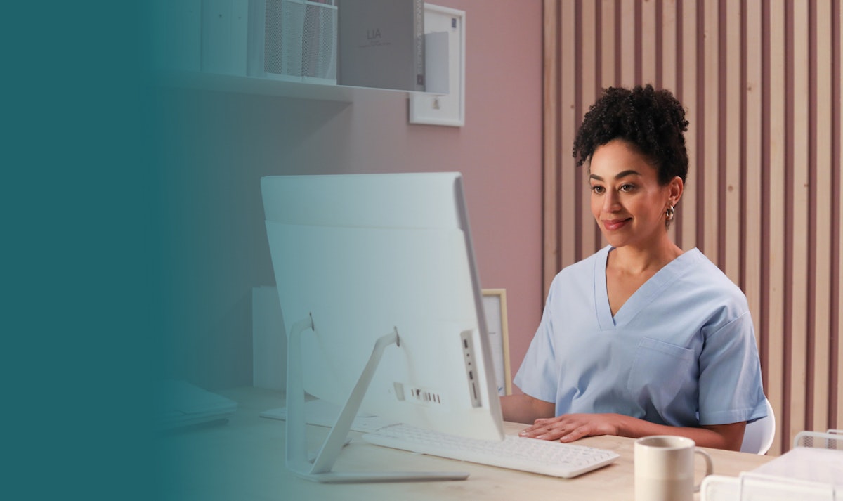 maternity nurse looking over a computer