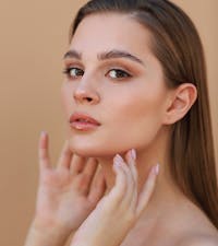 Woman touching the sides of her chin