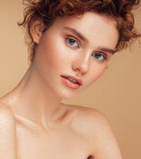 Red-headed woman looking at camera