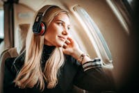 Woman looking out the window of an airplane