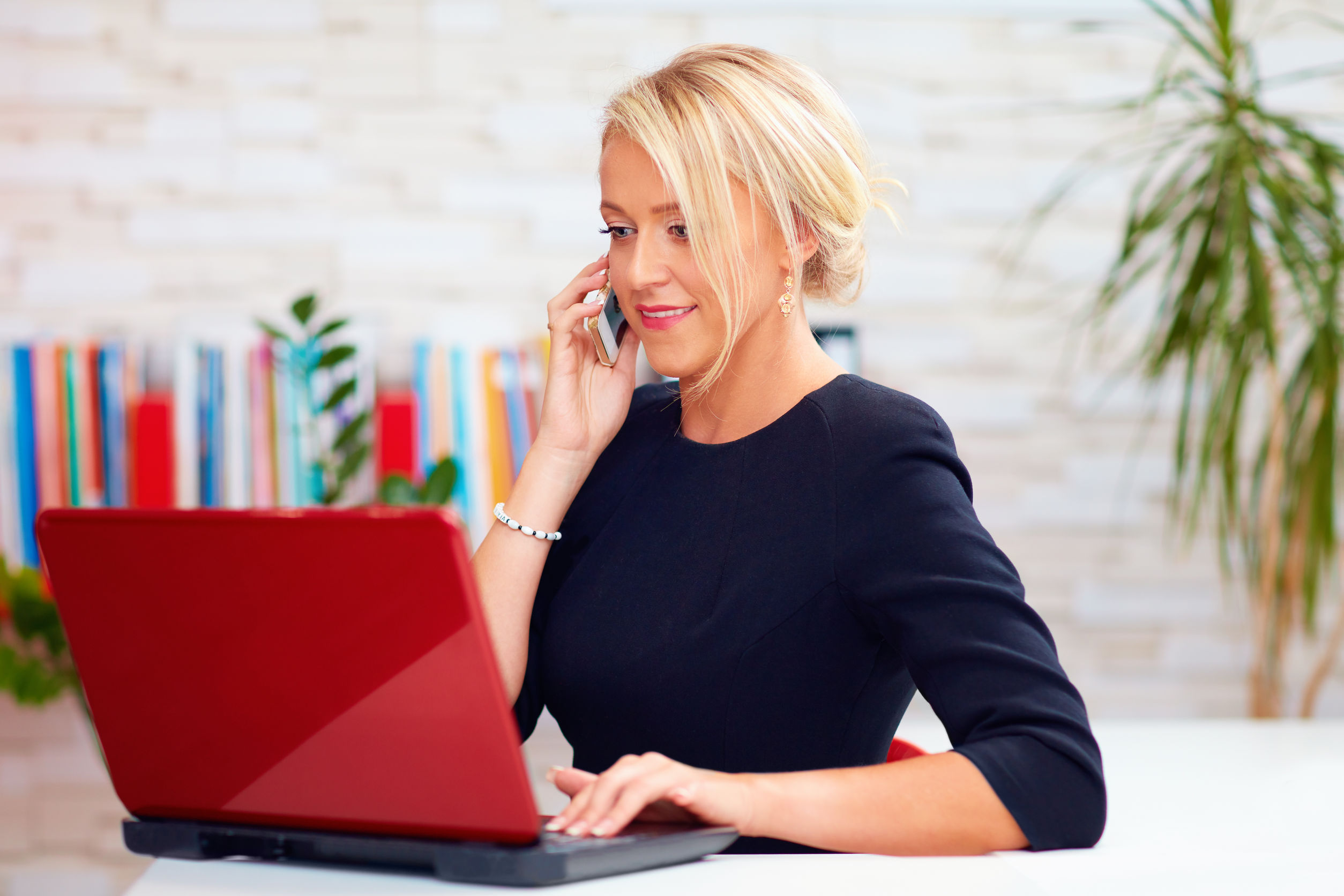 attractive business woman talking on the phone in office|a business team brainstorming together in the office|senior couple meeting financial adviser for investment
