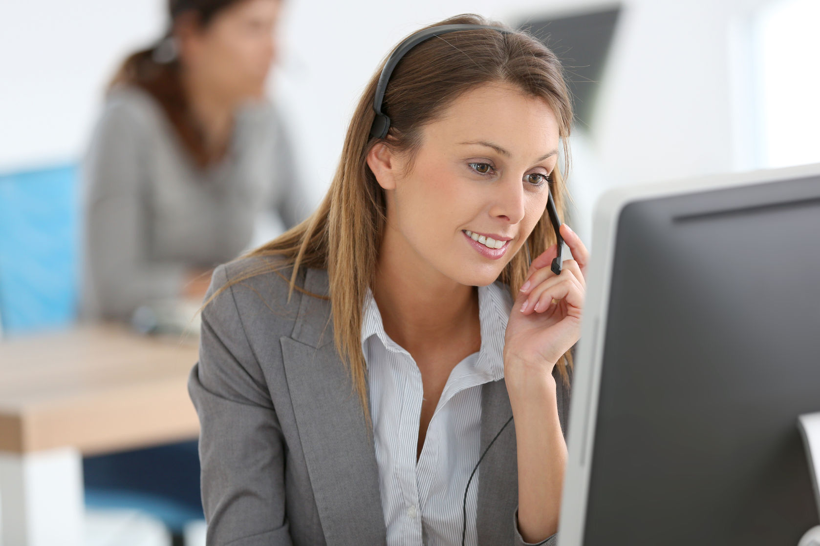 smiling customer service representative at work|feng shui flexibility|female hands with pen writing on notebook