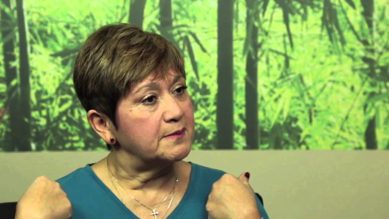 woman sitting in front of a green background