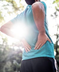 man holding his lower back