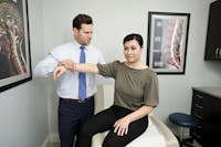 Dr. Porter assiting female patient with sports medicine in New Jersey
