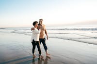 Wife and husband walking on the beach