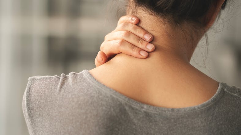 Person touching neck in pain