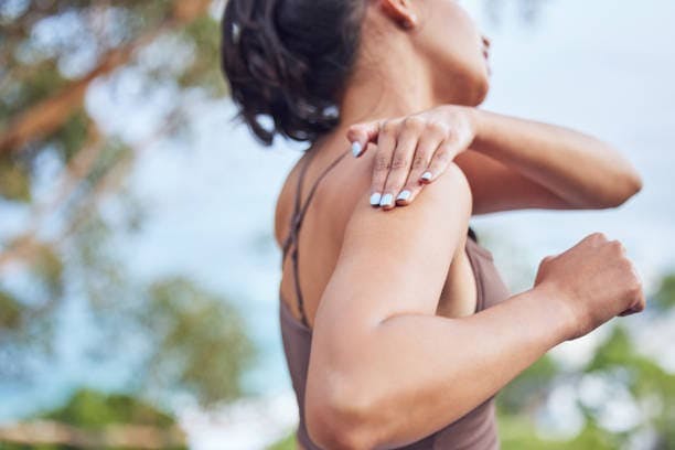 Woman with hurt shoulder