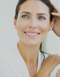 Women Touching Her Hair And Smiling