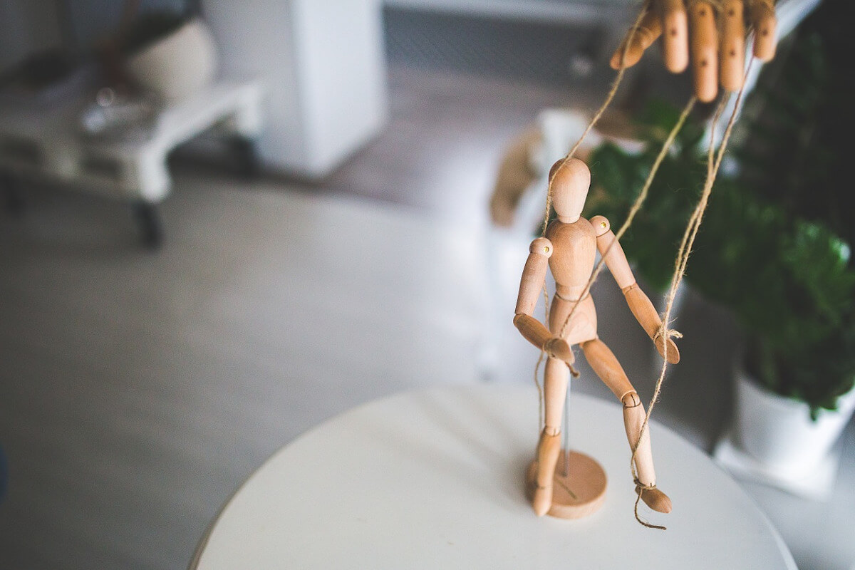 marionette with hand halding strings