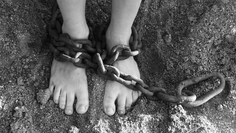 feet with chains on ankles