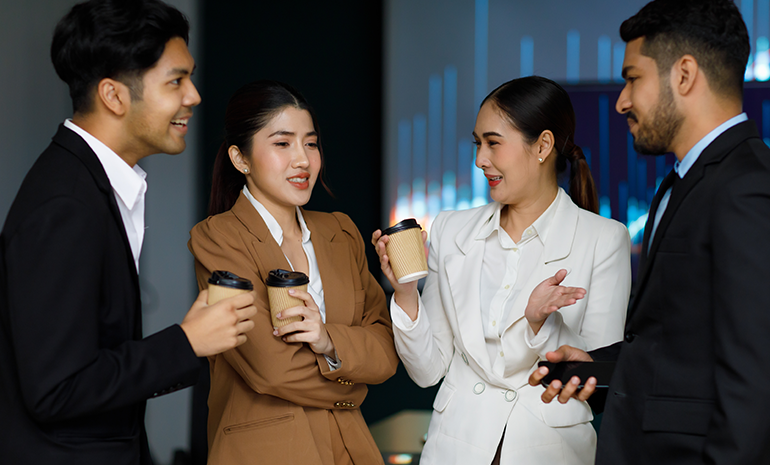Happy employees interacting with each other during a coffee break