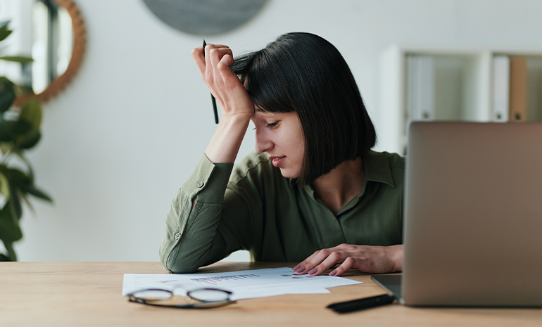 An employee facepalming herself.