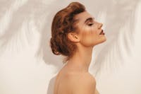 Beautiful Women Side Profile View And Shadows Of Palm Trees