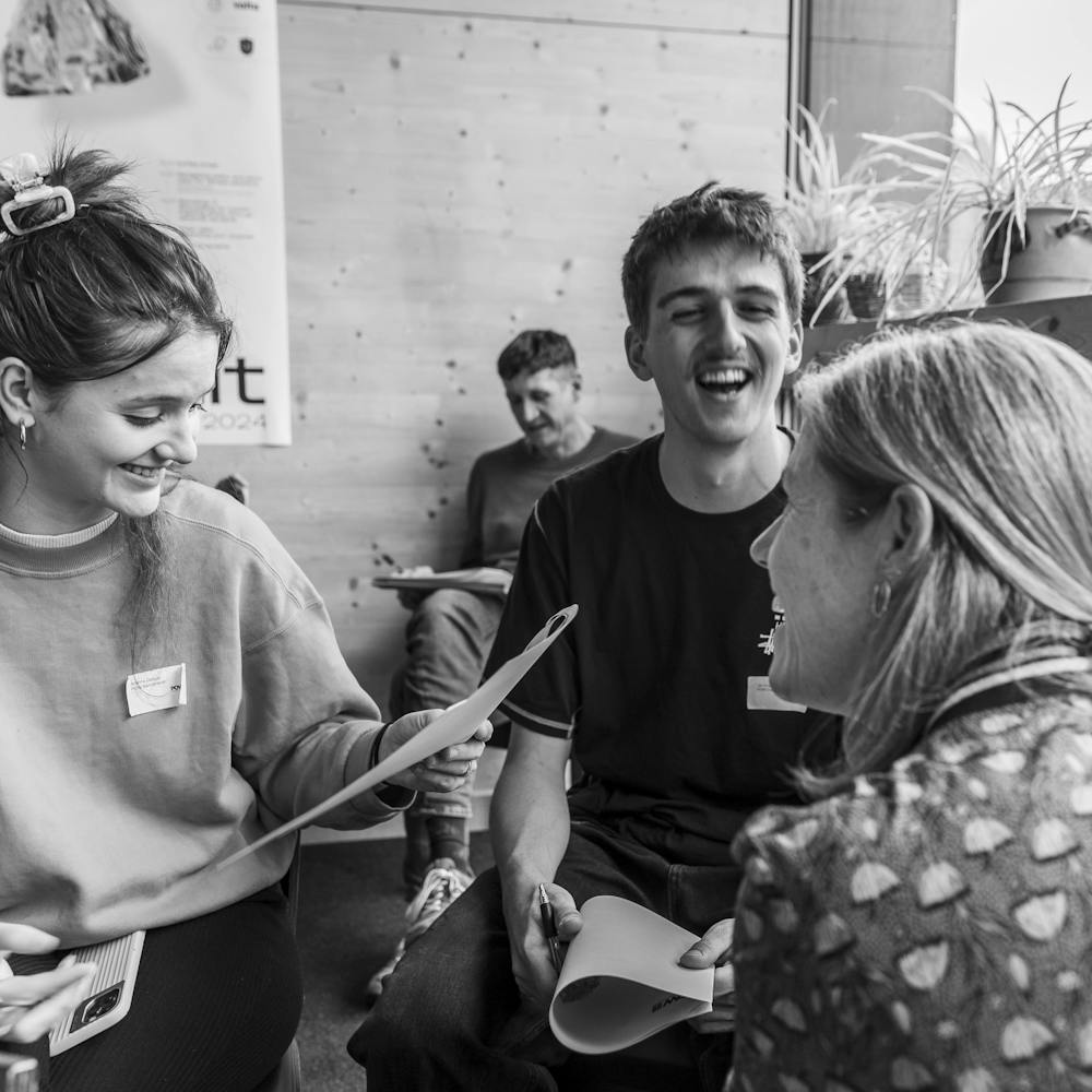 People interacting and laughing at the Summit during the workshop